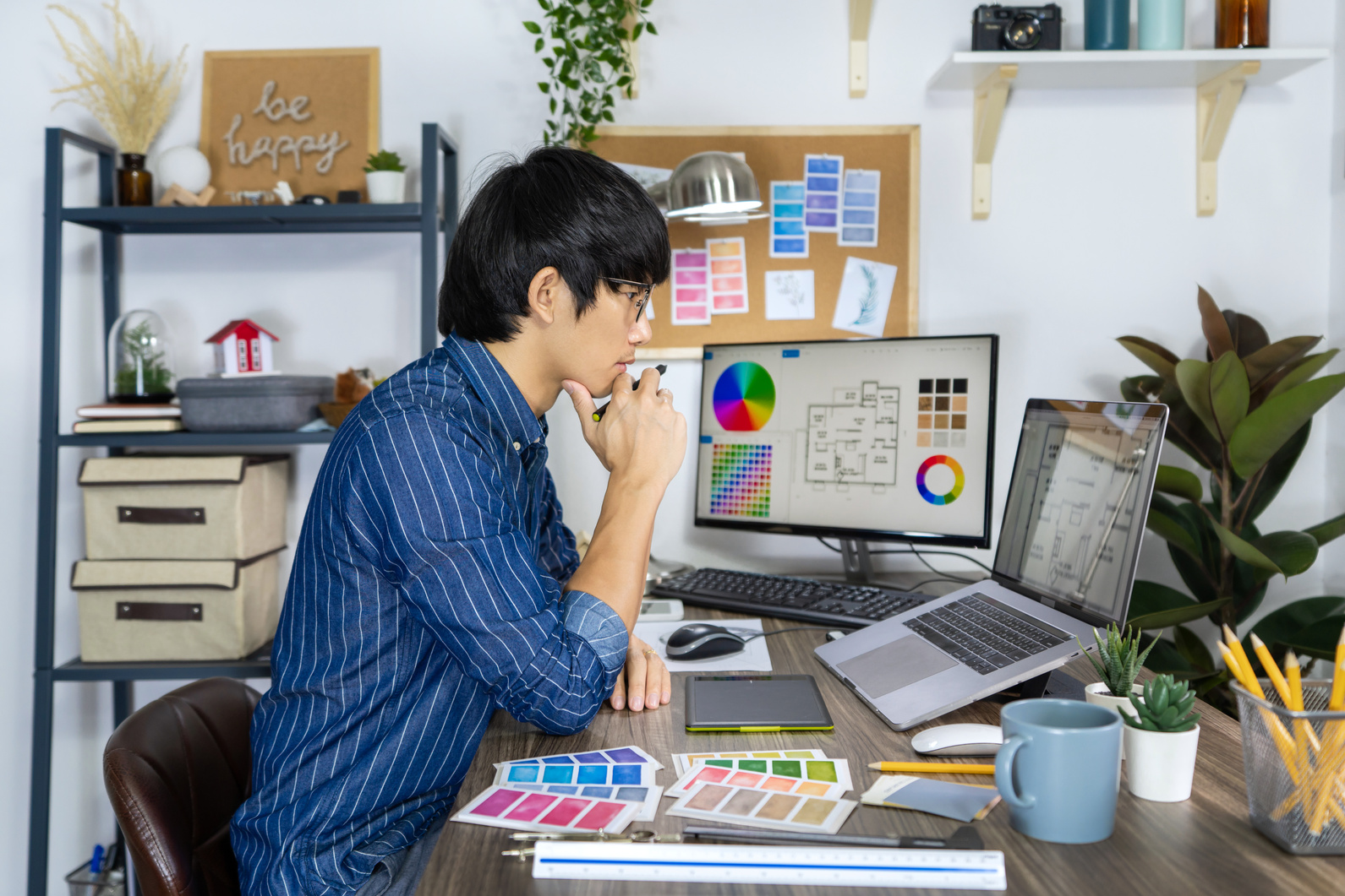 Asian Men Architect or Graphic Designer Designing a Layout Selec